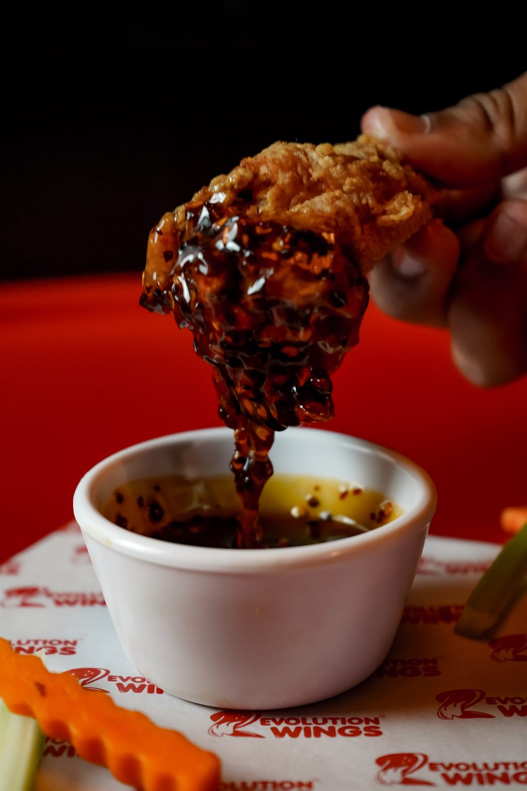 Alita de pollo crujiente bañada en salsa de la casa de Revolution Wings